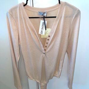 Long sleeved beige bodysuit